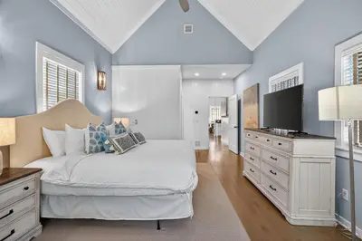 a bedroom with a white bed and a tv at 231 Saltbox Lane - Near Beach Home with Community Pool in Watersound in Watersound Beach