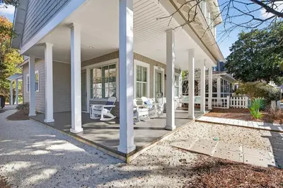 a porch of a house with white columns at 231 Saltbox Lane - Near Beach Home with Community Pool in Watersound in Watersound Beach