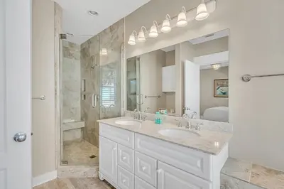 a bathroom with two sinks and a shower at 30A Monterey B201 - Gulf Front Condo Near Alys Beach in Seacrest