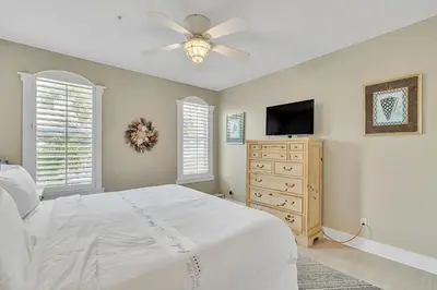 a bedroom with a bed and a flat screen tv at 30A Monterey B201 - Gulf Front Condo Near Alys Beach in Seacrest