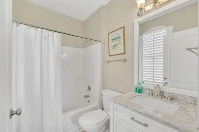 a white bathroom with a toilet and a sink at 30A Monterey B201 - Gulf Front Condo Near Alys Beach in Seacrest