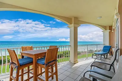 a balcony with a table and chairs and the ocean at 30A Monterey B201 - Gulf Front Condo Near Alys Beach in Seacrest