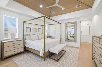 a bedroom with a canopy bed and a dresser at 30A Backyard Paradise - Huge Luxury Vacation Home with Gulf Views & Private Pool in Rosemary Beach