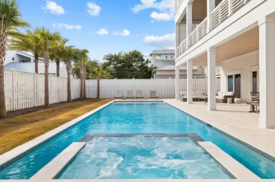 a swimming pool in the backyard of a house at 30A Backyard Paradise - Huge Luxury Vacation Home with Gulf Views & Private Pool in Rosemary Beach