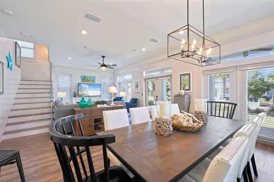 a dining room and living room with a table and chairs at Arrabella - Gulf Views with Deck & Community Pool in Santa Rosa Beach