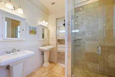 a bathroom with two sinks and a glass shower at Arrabella - Gulf Views with Deck & Community Pool in Santa Rosa Beach