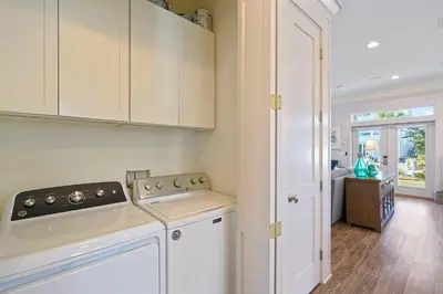 a kitchen with white cabinets and a stove at Arrabella - Gulf Views with Deck & Community Pool in Santa Rosa Beach