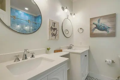a white bathroom with a sink and a mirror at Beach Baby - Secluded Home with Private Pool Area & Deck in Santa Rosa Beach
