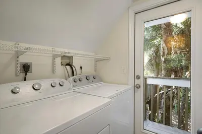 a white laundry room with a sink and a window at Beach Baby - Secluded Home with Private Pool Area & Deck in Santa Rosa Beach