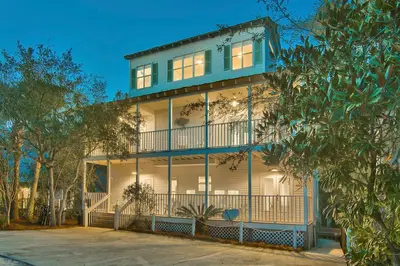 a blue house with a balcony on a street at Beach Baby - Secluded Home with Private Pool Area & Deck in Santa Rosa Beach