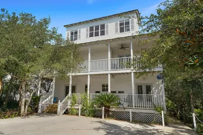 a white house with a white fence in front of it at Beach Baby - Secluded Home with Private Pool Area & Deck in Santa Rosa Beach