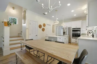 a kitchen and dining room with a wooden table and chairs at Beach Baby - Secluded Home with Private Pool Area & Deck in Santa Rosa Beach