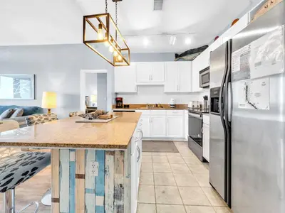 a kitchen with white cabinets and a large kitchen island at Laketown Wharf 2031 in Panama City Beach