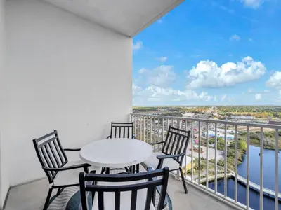 a balcony with a table and chairs and a view at Laketown Wharf 2031 in Panama City Beach