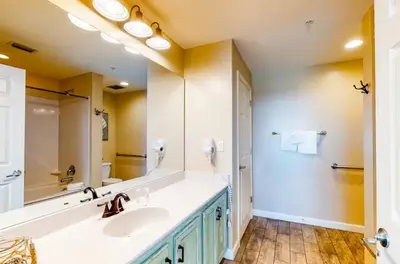 a bathroom with a sink and a large mirror at Sterling Reef 505 by Emerald Coast Retreats in Panama City Beach