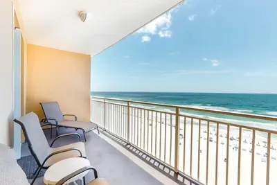 a balcony with chairs and a view of the ocean at Sterling Reef 505 by Emerald Coast Retreats in Panama City Beach