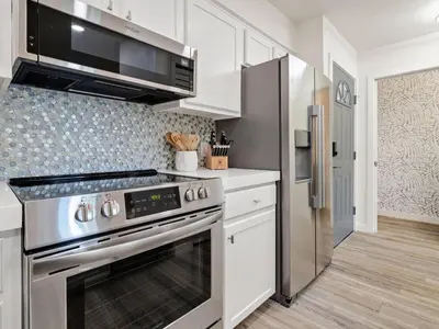 a kitchen with a stainless steel stove and refrigerator at Cassine Gardens #270 - The Getaway in Santa Rosa Beach