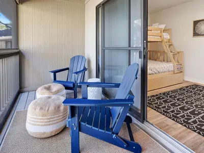 a room with two blue chairs and a bunk bed at Cassine Gardens #270 - The Getaway in Santa Rosa Beach