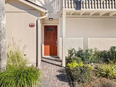 a house with a red door and a brick walkway at Cassine Gardens #270 - The Getaway in Santa Rosa Beach