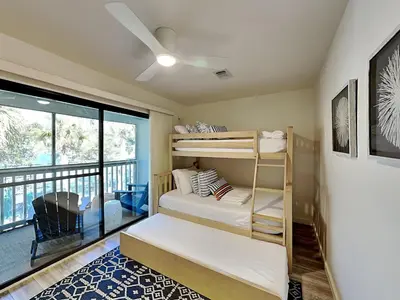 a bedroom with bunk beds and a balcony at Cassine Gardens #270 - The Getaway in Santa Rosa Beach