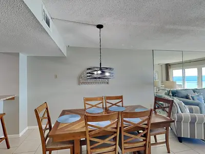 a dining room with a table and chairs at Dunes of Panama #D705 in Panama City Beach