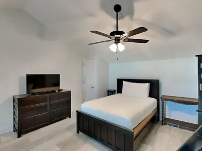 a bedroom with a bed and a ceiling fan at Treasure Cove #D308 - Paradise City in Panama City Beach