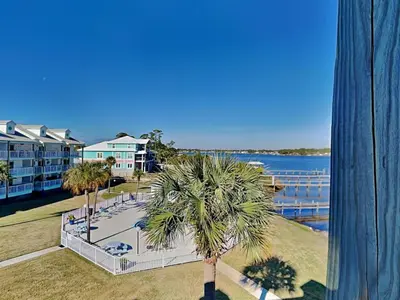 a view of a resort with a palm tree at Treasure Cove #D308 - Paradise City in Panama City Beach
