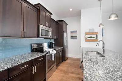 a kitchen with wooden cabinets and a counter top at Seacrest Paradise Spacious 4 bedroom retreat in Inlet Beach, perfect for 13 guests in Inlet Beach