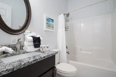 a bathroom with a sink and a toilet and a mirror at Seacrest Paradise Spacious 4 bedroom retreat in Inlet Beach, perfect for 13 guests in Inlet Beach