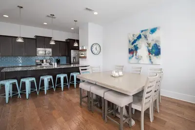a kitchen and dining room with a table and chairs at Seacrest Paradise Spacious 4 bedroom retreat in Inlet Beach, perfect for 13 guests in Inlet Beach