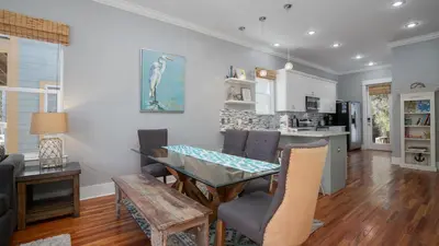 a dining room and kitchen with a table and chairs at Experience luxury at Doctor in Inlet Beach