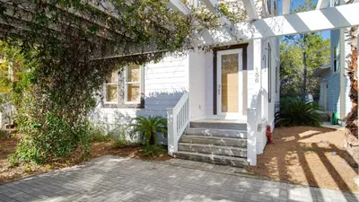 a white house with stairs and ivy at Experience luxury at Doctor in Inlet Beach