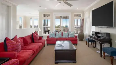 a living room with red couches and a flat screen tv at Experience luxury at Doctor in Inlet Beach