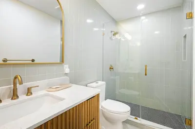 a bathroom with a sink and a toilet and a shower at Sol Haus Stylish Coastal Retreat 3 Blocks to Beach Screened Porch Fast Wi Fi in Panama City Beach