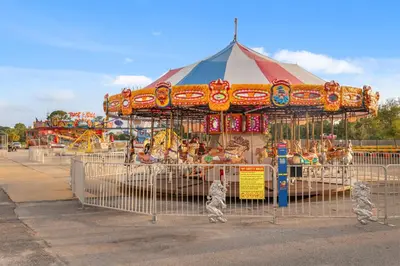 a carnival with a carousel in a park at Billie Jean’s Bungalow! Cozy Edgewater Condo w/ Resort Amenities, Sleeps 6 in Panama City Beach