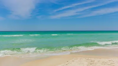 a view of the ocean with a sandy beach at Sunset Cove: Charming 3BR/3BA Beach House Sleeps 8 with Sunsets & Serenity in Panama City Beach