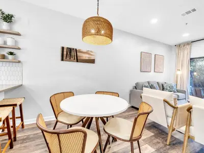 a living room with a table and chairs and a couch at Heron's Watch Way 1102 in Santa Rosa Beach