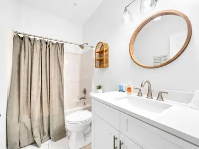 a bathroom with a sink and a toilet and a mirror at Heron's Watch Way 1102 in Santa Rosa Beach