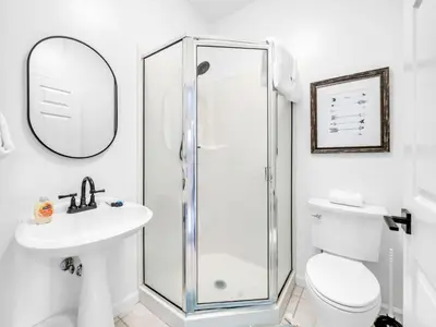 a bathroom with a shower and a toilet and a sink at Heron's Watch Way 1102 in Santa Rosa Beach
