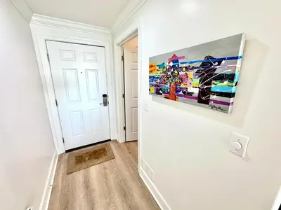 a room with a painting hanging on a wall at Ocean Reef 1002 in Panama City Beach