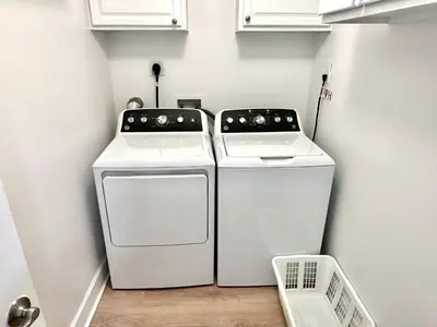 two washing machines sitting next to each other in a laundry room at Ocean Reef 1002 in Panama City Beach