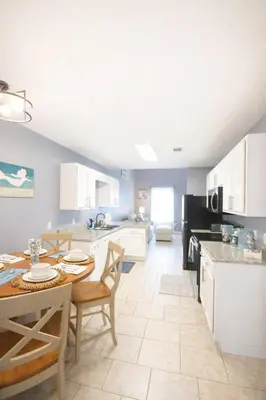 a kitchen and dining room with a table and chairs at WALK TO BEACH Perfect Family Getaway Sleep 6 in Panama City Beach