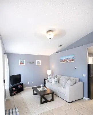 a living room with a white couch and a table at WALK TO BEACH Perfect Family Getaway Sleep 6 in Panama City Beach