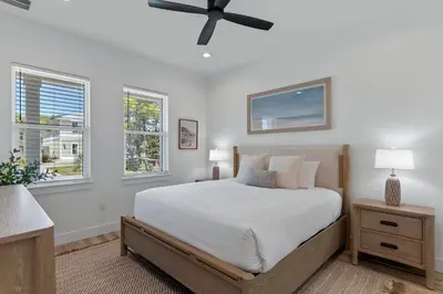 a bedroom with a bed and a ceiling fan at The Gathering Place by Travel Life Vacations in Santa Rosa Beach