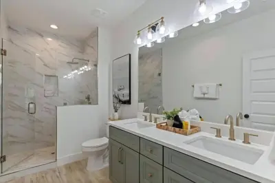 a bathroom with a sink and a toilet and a shower at The Gathering Place by Travel Life Vacations in Santa Rosa Beach