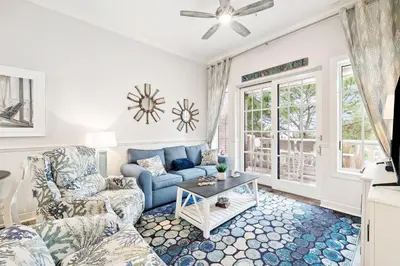 a living room with a couch and a table at The Magnolia by 30A Escapes in Rosemary Beach