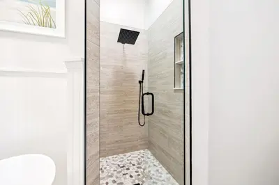 a bathroom with a shower with a glass door at The Magnolia by 30A Escapes in Rosemary Beach