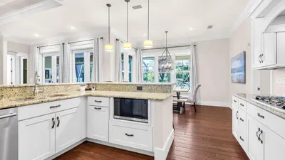 a kitchen with white cabinets and a counter top at Sea Breeze on 30A in Seacrest