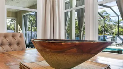 a wooden bowl sitting on top of a wooden table at Sea Breeze on 30A in Seacrest