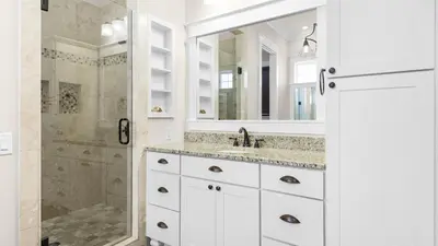 a white bathroom with a shower and a sink at Sea Breeze on 30A in Seacrest